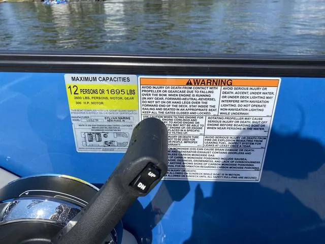 Slide: The Image of 2021 Sylvan L-3 DLZ boat capacity and warning labels near water. - 7