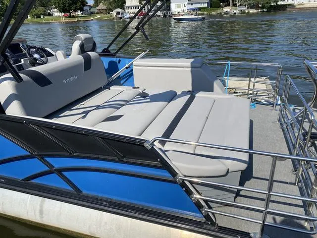 Slide: The Image of 2021 Sylvan L-3 DLZ pontoon boat with spacious seating on a sunny lake. - 9