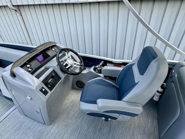 Slide: The Image of 2022 Bennington 25 LTSB boat helm with modern steering and comfortable seating. - 17