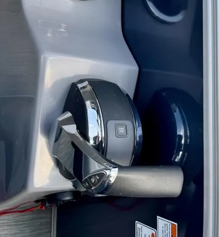 Slide: The Image of Throttle control of a 2022 Bennington 25 LTSB boat, featuring sleek design and chrome finish. - 18