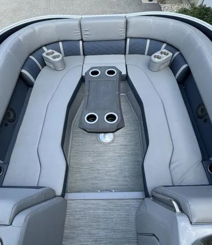 Slide: The Image of 2022 Bennington 25 LTSB boat interior with gray seating and cup holders. - 19