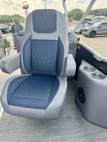 Slide: The Image of 2022 Bennington 25 LTSB boat seat with cup holders, featuring blue and gray upholstery. - 20