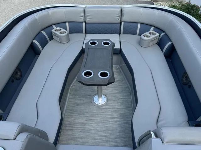 Slide: The Image of 2022 Bennington 25 LTSB boat interior with gray seating and cup holders. - 21