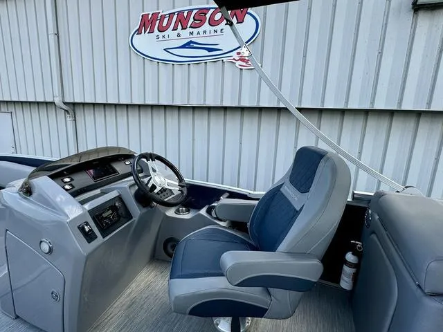 Slide: The Image of 2022 Bennington 25 LTSB boat interior with captain's chair and control panel. - 22