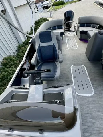 Slide: The Image of 2022 Bennington 25 LTSB pontoon boat interior with modern seating and steering console. - 24