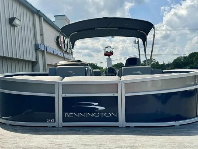Slide: The Image of 2022 Bennington 25 LTSB pontoon boat with canopy, displayed outdoors. - 3