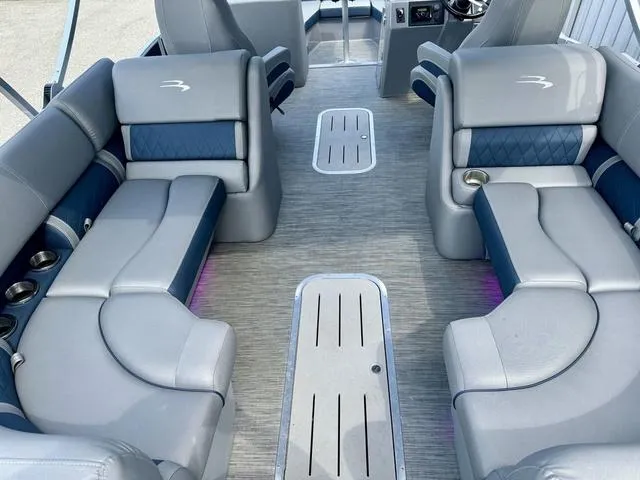 Slide: The Image of 2022 Bennington 25 LTSB boat interior with gray and blue seating. - 30