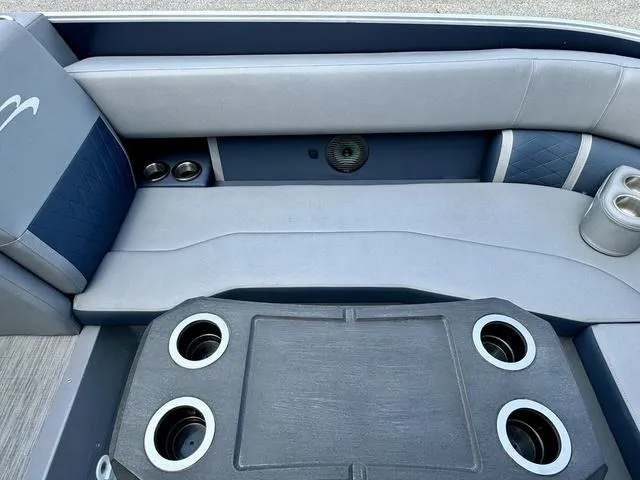 Slide: The Image of 2022 Bennington 25 LTSB boat interior with cushioned seating and cup holders. - 31