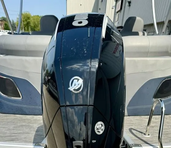 Slide: The Image of 2022 Bennington 25 LTSB boat with a sleek black Mercury outboard motor. - 35