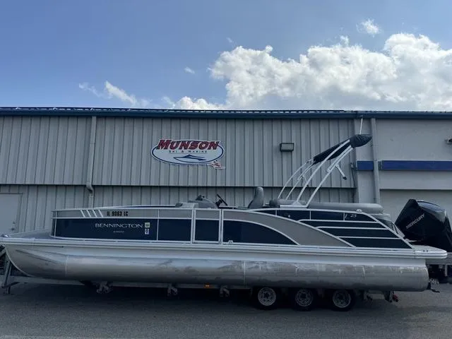 Slide: The Image of 2022 Bennington 25 LTSB pontoon boat parked outside Munson Marine building. - 4