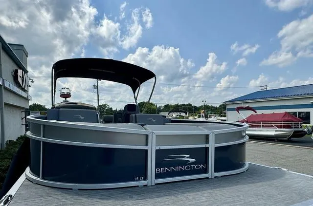 Slide: The Image of 2022 Bennington 25 LTSB pontoon boat under a cloudy sky at a marina. - 8
