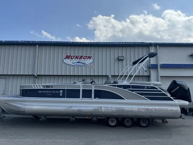 Slide: The Image of 2022 Bennington 25 LTSB pontoon boat on trailer, parked outside Munson building. - 9