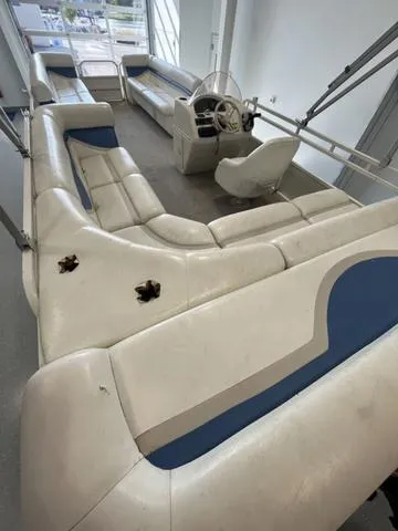 Slide: The Image of 2006 Bentley Pontoons Duracraft 24 Cruise interior with white and blue seating. - 4