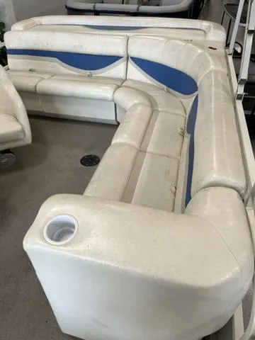 Slide: The Image of 2006 Bentley Pontoons Duracraft 24 Cruise interior seating with white and blue upholstery. - 5