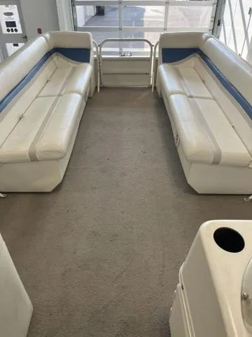 Slide: The Image of 2006 Bentley Pontoons Duracraft 24 Cruise interior with white and blue seating. - 6
