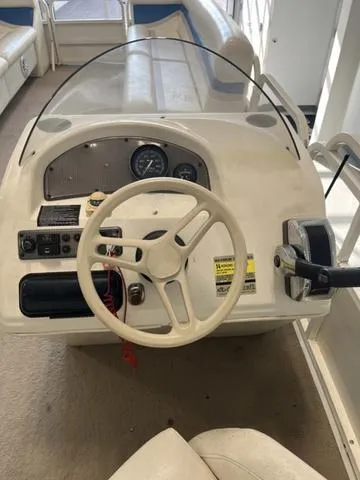 Slide: The Image of 2006 Bentley Pontoons Duracraft 24 Cruise dashboard with steering wheel and controls. - 8