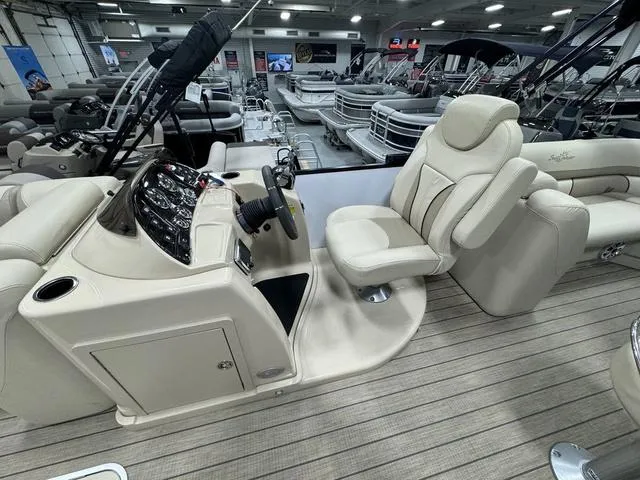 Slide: The Image of 2019 SunChaser 8525 Entertainer boat interior with beige seating and control panel. - 11