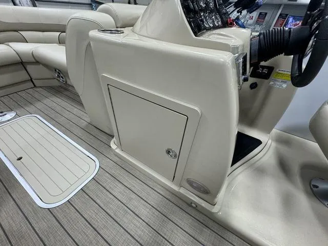 Slide: The Image of 2019 SunChaser 8525 Entertainer boat interior with beige seating and wood-style flooring. - 16