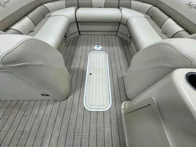Slide: The Image of Interior of 2019 SunChaser 8525 Entertainer boat with beige seating and wood-style flooring. - 18