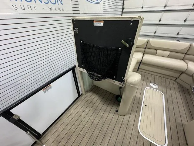 Slide: The Image of 2019 SunChaser 8525 Entertainer boat interior with seating and storage features. - 20