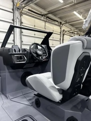 Slide: The Image of 2024 Axis Wake Research A245 boat interior with modern steering and seating. - 10