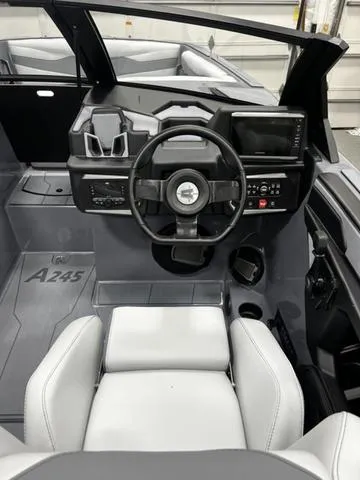 Slide: The Image of 2024 Axis Wake Research A245 boat interior with modern dashboard and steering wheel. - 12