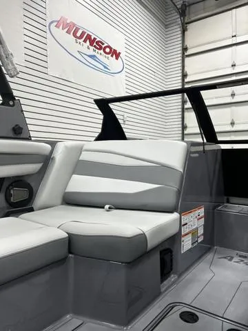 Slide: The Image of 2024 Axis Wake Research A245 boat interior with gray seating in showroom. - 14
