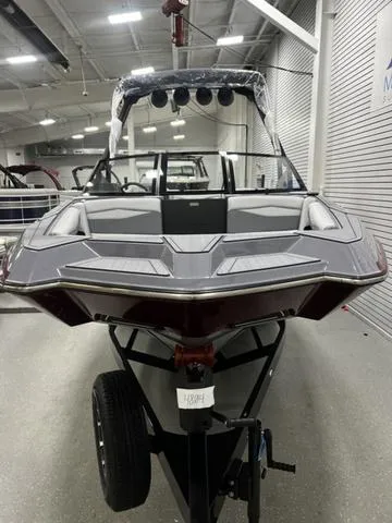 Slide: The Image of 2024 Axis Wake Research A245 boat in showroom, front view, sleek design, modern features. - 3