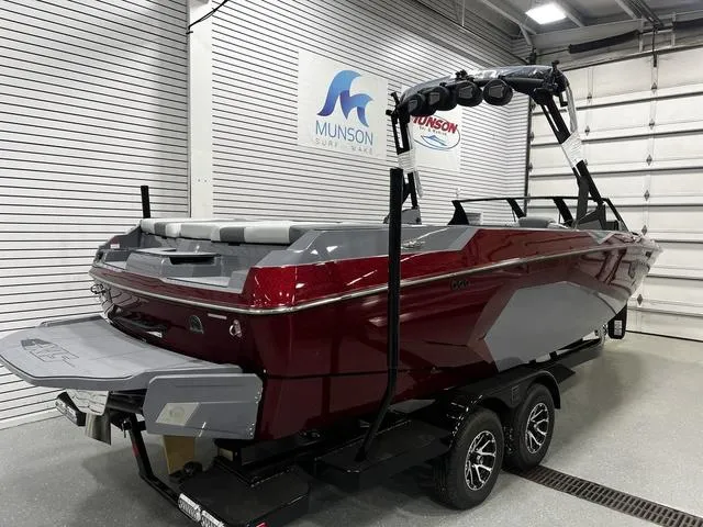 Slide: The Image of 2024 Axis Wake Research A245 boat in showroom, red and gray design, on trailer. - 4