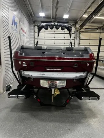 Slide: The Image of 2024 Axis Wake Research A245 boat in a showroom, rear view with wakeboard tower. - 5