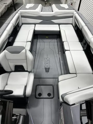 Slide: The Image of 2024 Axis Wake Research A245 boat interior with sleek white and gray seating. - 9
