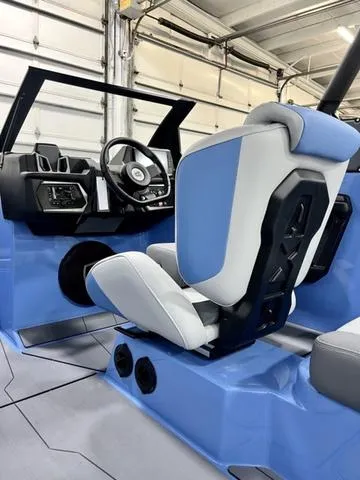 Slide: The Image of 2024 Axis Wake Research T250 boat interior with blue and white seating and modern dashboard. - 11