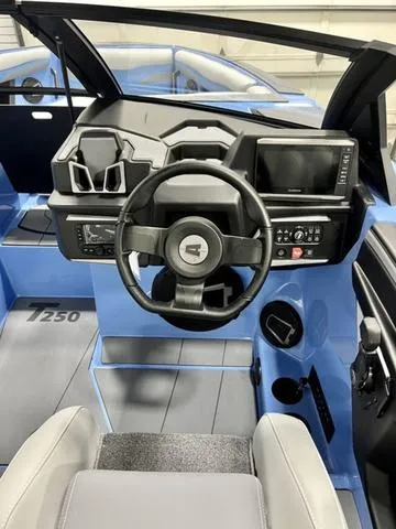 Slide: The Image of 2024 Axis Wake Research T250 boat interior with modern dashboard and steering wheel. - 13