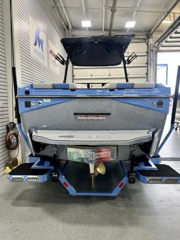 Slide: The Image of 2024 Axis Wake Research T250 boat in a garage, rear view. - 5