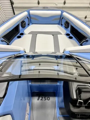 Slide: The Image of 2024 Axis Wake Research T250 boat interior with blue and white seating. - 8