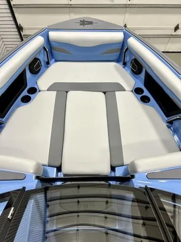 Slide: The Image of 2024 Axis Wake Research T250 boat interior with blue and gray seating. - 9