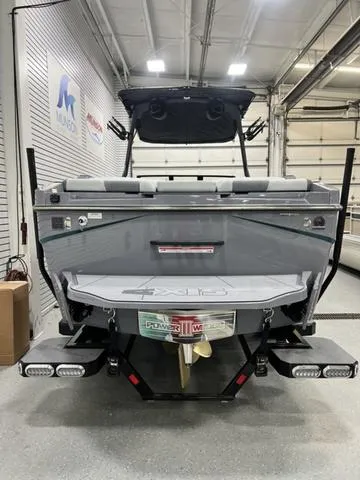 Slide: The Image of 2024 Axis Wake Research T250 boat in a showroom, rear view. - 10