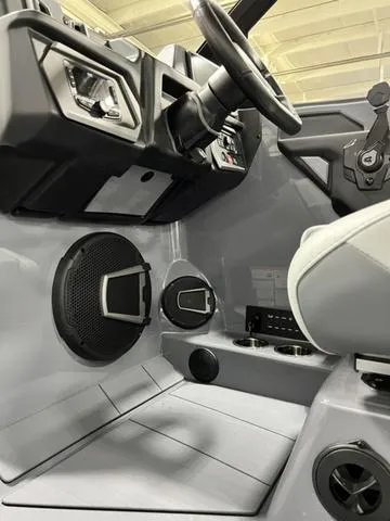 Slide: The Image of 2024 Axis Wake Research T250 boat interior with steering wheel and speaker system. - 20