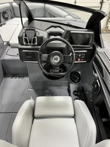 Slide: The Image of 2024 Axis Wake Research T250 boat interior with modern dashboard and steering wheel. - 21