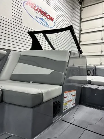 Slide: The Image of 2024 Axis Wake Research T250 boat interior with gray seating in showroom. - 22