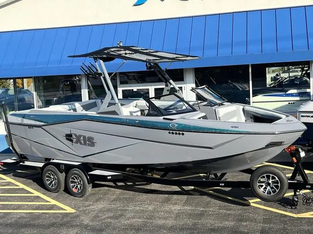 Slide: The Image of 2024 Axis Wake Research T250 boat on trailer, parked outside dealership. - 26