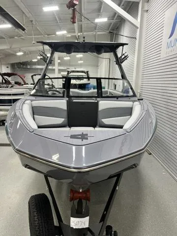 Slide: The Image of 2024 Axis Wake Research T250 boat in showroom, front view, sleek design, modern interior. - 8