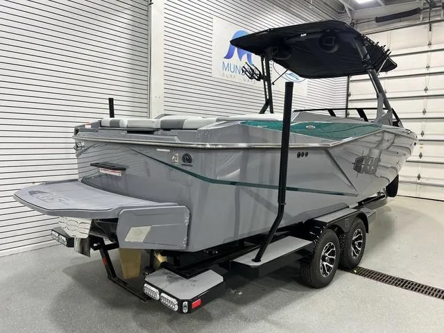 Slide: The Image of 2024 Axis Wake Research T250 boat in showroom, gray exterior, on trailer. - 9
