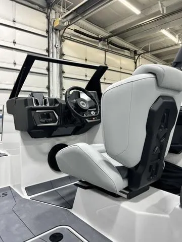Slide: The Image of 2024 Axis Wake Research A245 boat interior with modern steering and seating. - 12