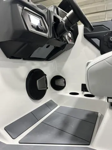 Slide: The Image of 2024 Axis Wake Research A245 boat interior dashboard and controls. - 13