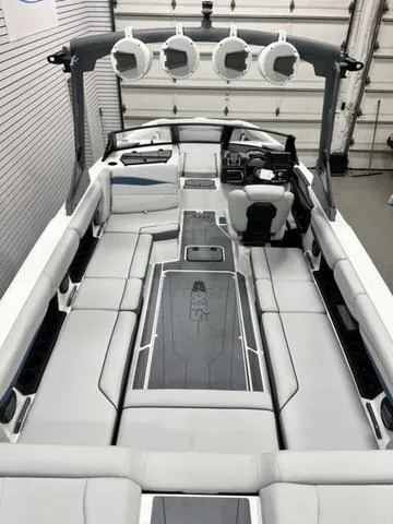 Slide: The Image of 2024 Axis Wake Research A245 boat interior with sleek seating and advanced audio system. - 6
