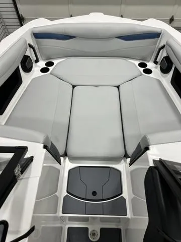 Slide: The Image of 2024 Axis Wake Research A245 boat interior with gray seating and cup holders. - 9