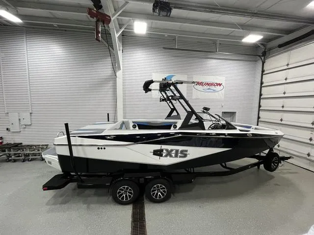 The Image of 2024 Axis Wake Research T235 boat in a showroom, featuring sleek design and modern features. - 1