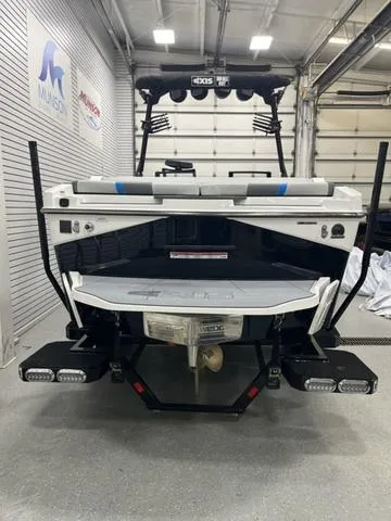 Slide: The Image of 2024 Axis Wake Research T235 boat in a showroom, rear view. - 4