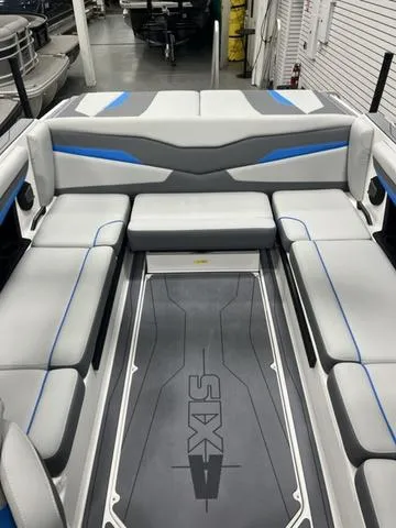 Slide: The Image of 2024 Axis Wake Research T235 boat interior with gray and blue seating. - 6